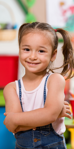 young girl student with pony tails smiling to camera young girl student with pony tails smiling to camera